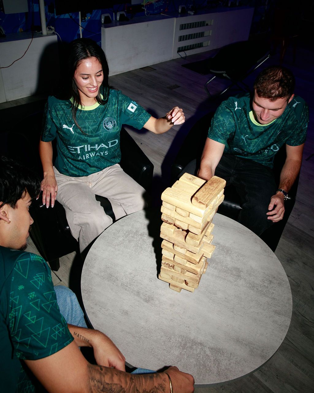 Manchester City players gathering around a tabletop game
