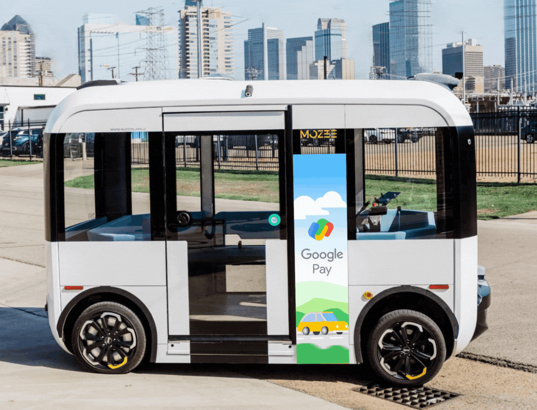 White autonomous shuttle with a digital side-panel advertisement