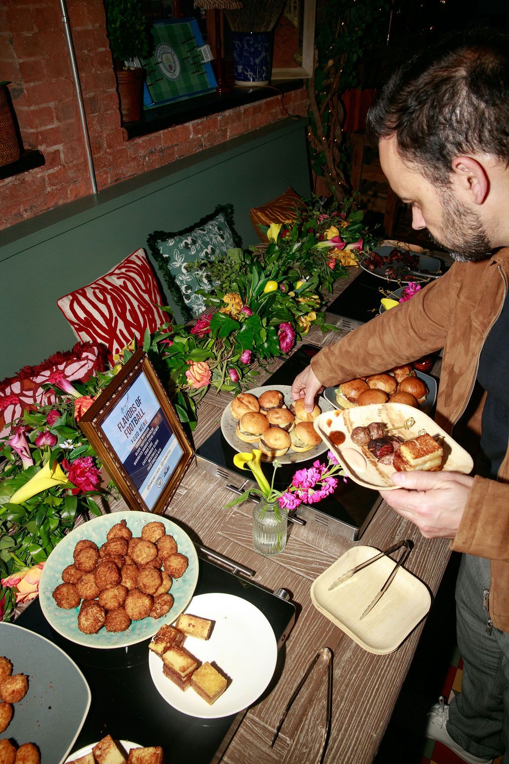 Guest selecting food from a buffet at the Asahi gathering