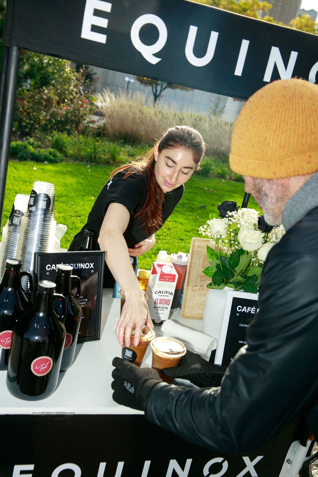 Barista serving a guest at the Café Equinox cart