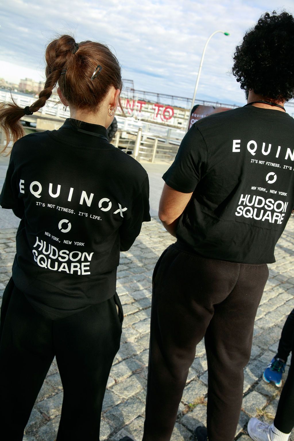 Two Equinox staff members facing the waterfront